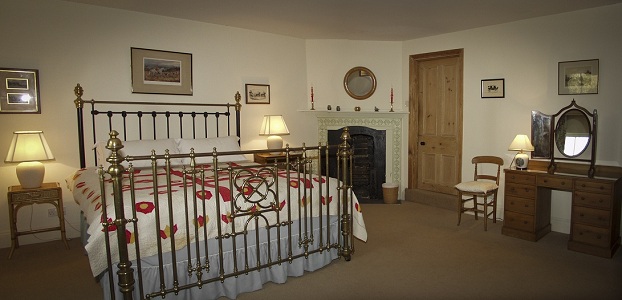 The Coach House double room with its antique brass bed